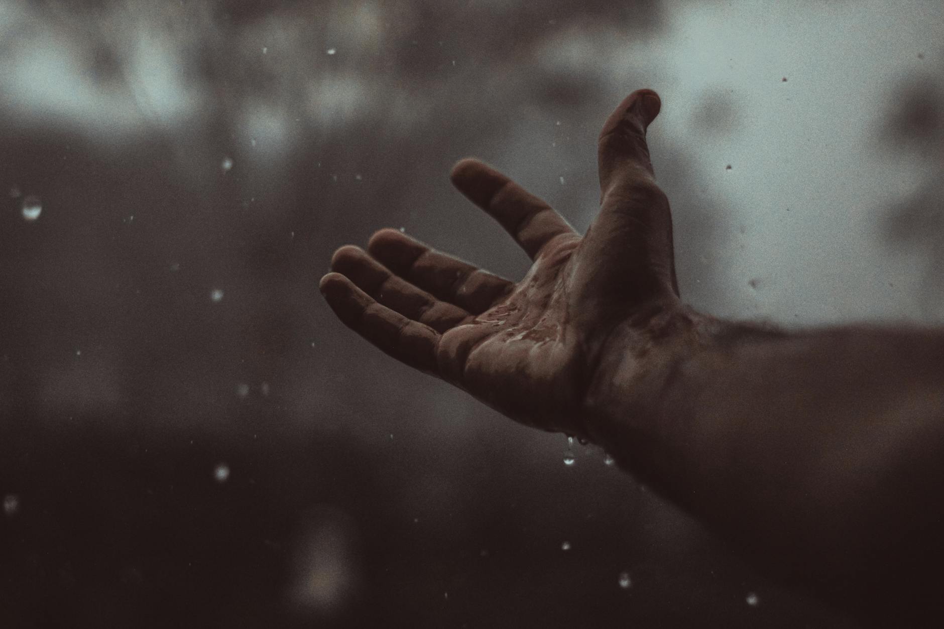 raindrops falling on a person s hand