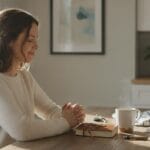 A Christian woman thoughtfully praying about how to serve God in her daily life