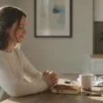 A Christian woman thoughtfully praying about how to serve God in her daily life