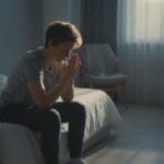 A person quietly praying alone, seeking strength to resist temptation